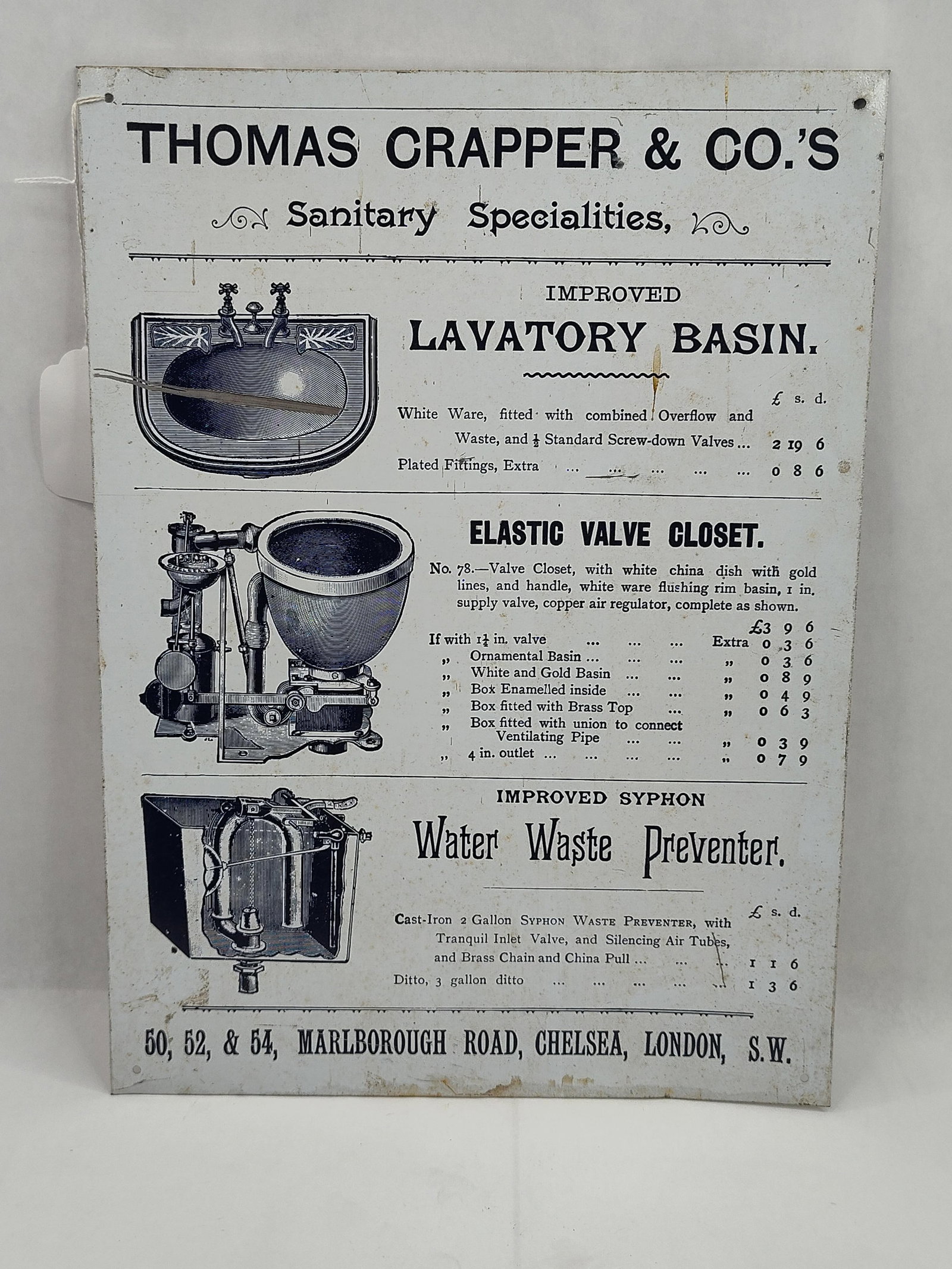 Thomas Crapper & Co. Metal Sign 1995: A rectangular British metal advertising sign featuring a reproduction of a Victorian-period catalog page. The white-enameled surface is printed in black ink with illustrations and pricing for three