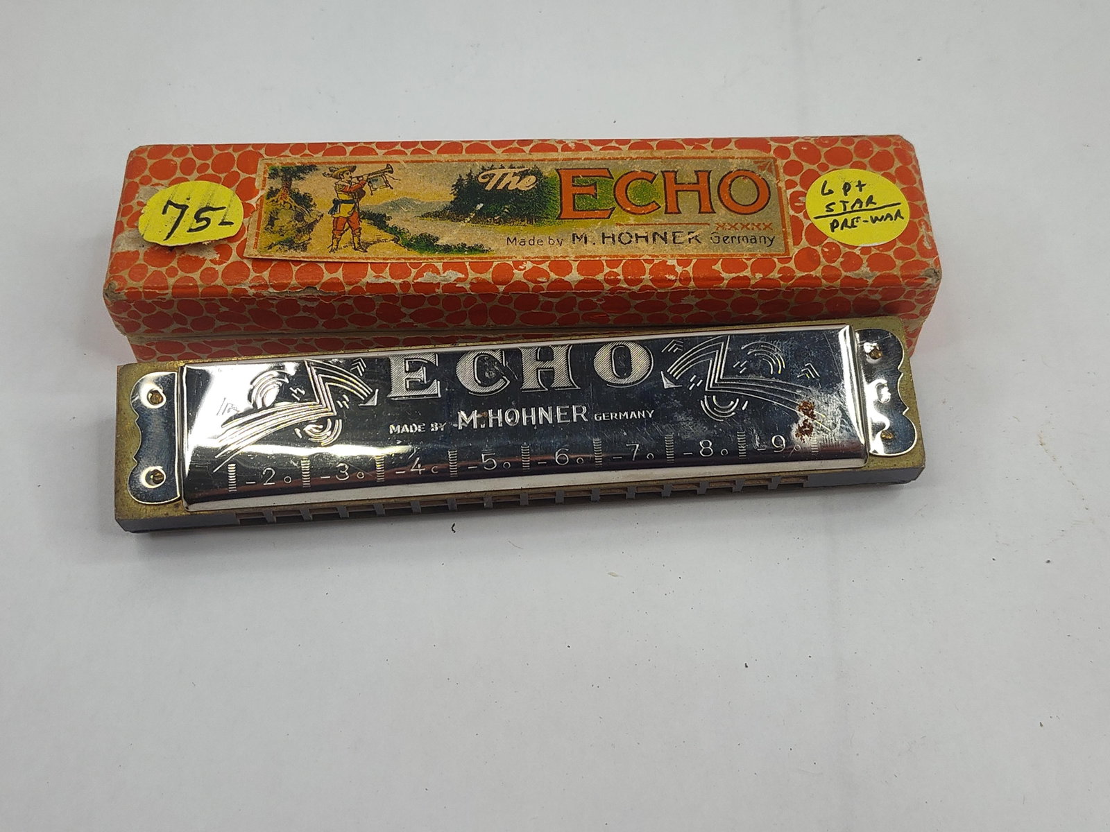 M. Hohner Echo Tremolo Harmonica w/ Box: A German tremolo harmonica featuring a wooden comb and chrome-plated cover plates. The upper cover plate is embossed with the model name ECHO in stylized block lettering, below which is the