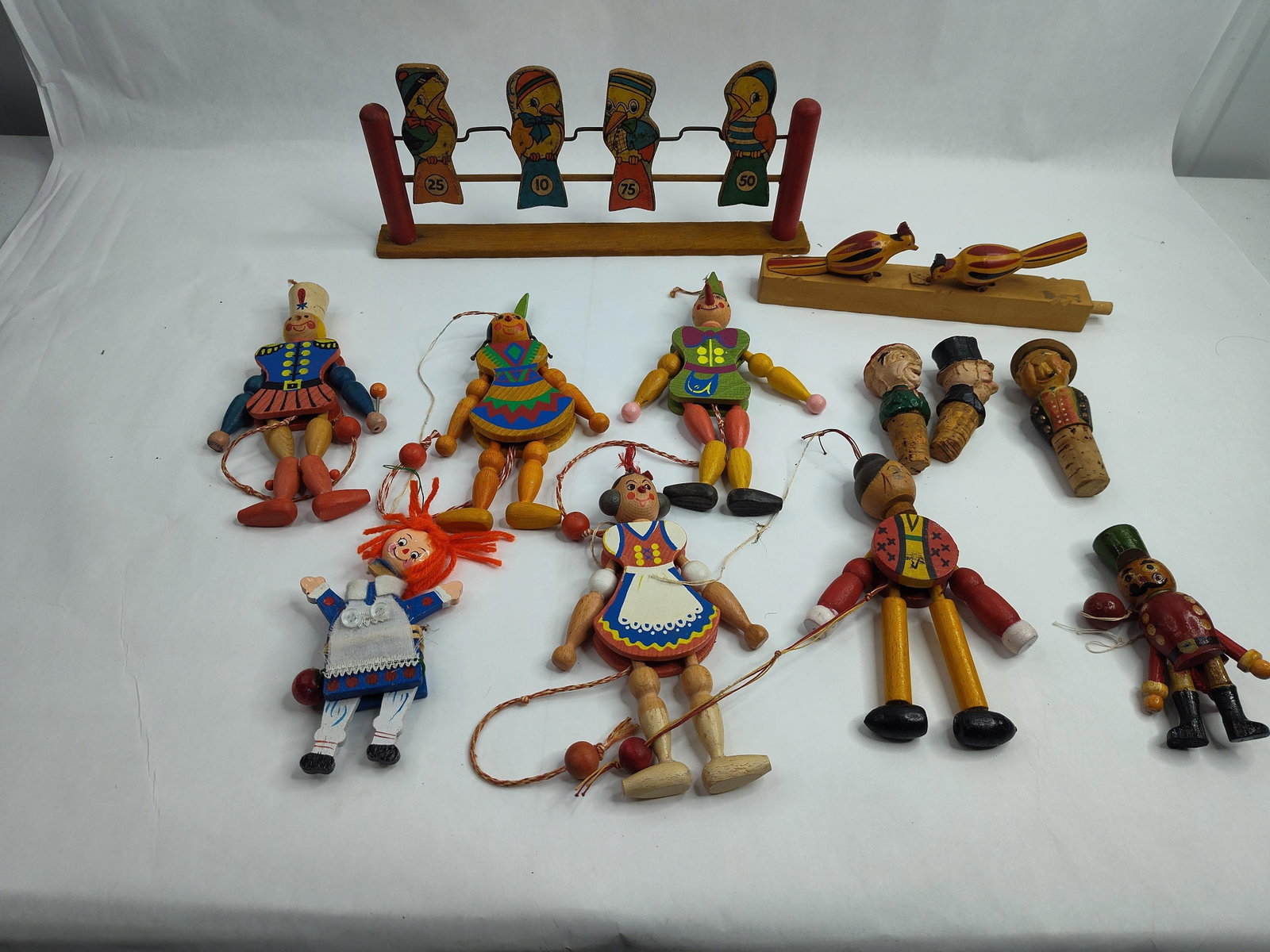 Hand-Painted Wood Folk Art Toy Set: A collection of hand-painted wooden folk art objects, comprising various mechanical toys, games, and decorative accessories. The group includes several "jumping jack" pull-string puppets, constructed 
