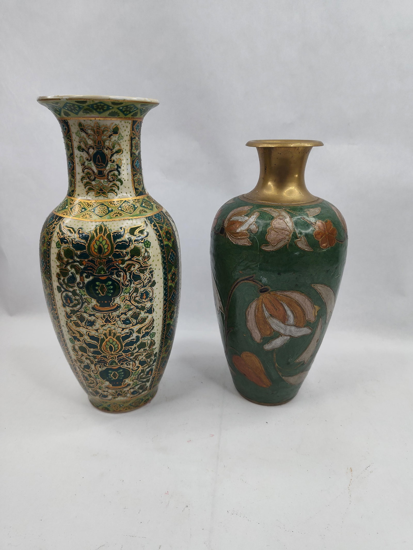 Set 2 Chinese Porc. & Champleve Vases: A collection of two Chinese decorative vases of varying materials and styles. The taller Chinese polychrome porcelain vase is of baluster form with a flared rim and foot. It features a textured cream-