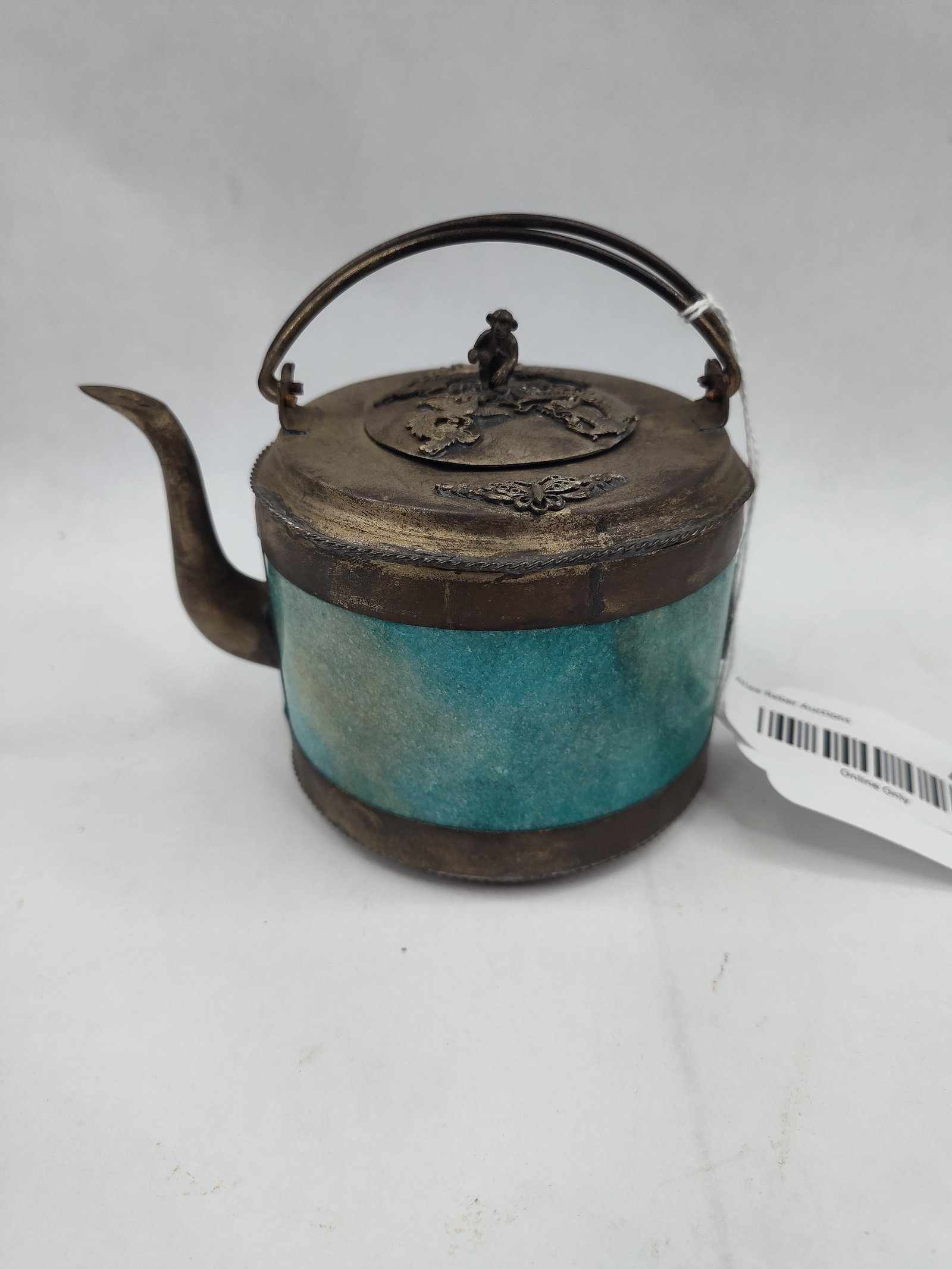 Metal & Hardstone Cylindrical Teapot: A decorative miniature teapot featuring a cylindrical body constructed with four inset panels of mottled turquoise-toned hardstone. The vessel is framed by dark-toned metal bands at the rim and base,