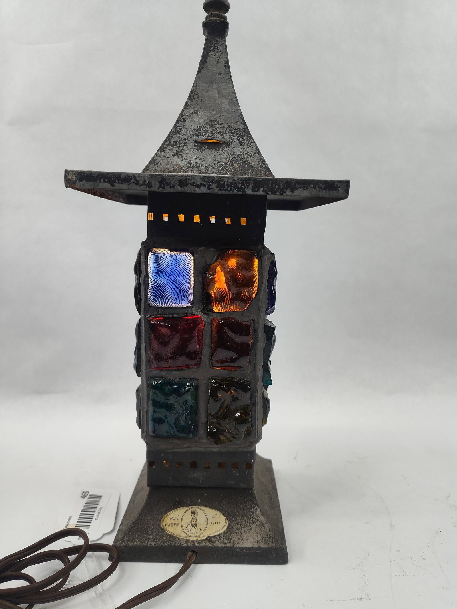 Nader Slab Glass & Metal Pagoda Lamp: A mid-century modern table lamp featuring a patinated metal frame and thick Dalle de Verre slab glass inserts. The design is influenced by Brutalist aesthetics, characterized by a square pagoda-style 