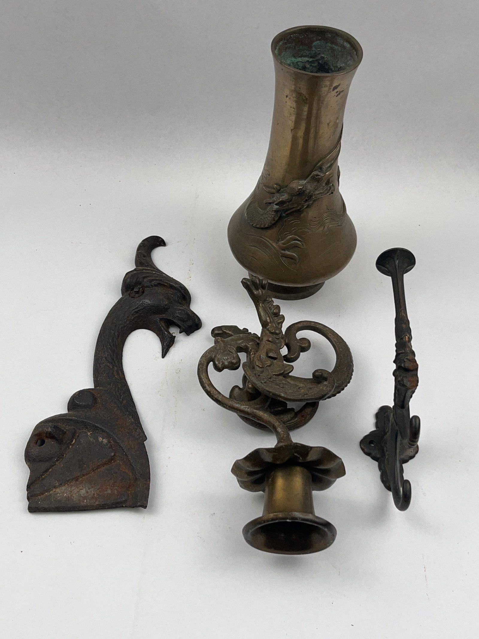 Bronze & Cast Iron Hardware & Decor: A collection of cast metal items including Asian-themed decorative pieces and architectural elements. The first item is a bronze vase featuring a flared rim and a bulbous body. The exterior is decorat