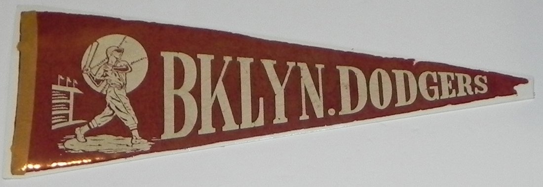 1950's Brooklyn Dodgers Baseball Pennant: This auction is for a 1950's Brooklyn Dodgers Batter themed pennant. This pennant has been shrinkwrapped (easily removed), and has a blunted tip, but it is an inexpensive example of vintage Brooklyn D