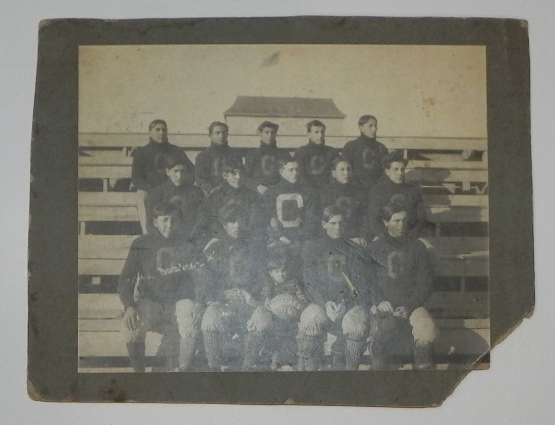 1906 Chilocco Indian School Football Team Cabinet Photo: This lot is for a fantastic 1906 Chilocco Indian School Football Team Photograph. The team is posing in their C adorned sweaters, with an adorable young Native American Boy mascot, who is holding a me