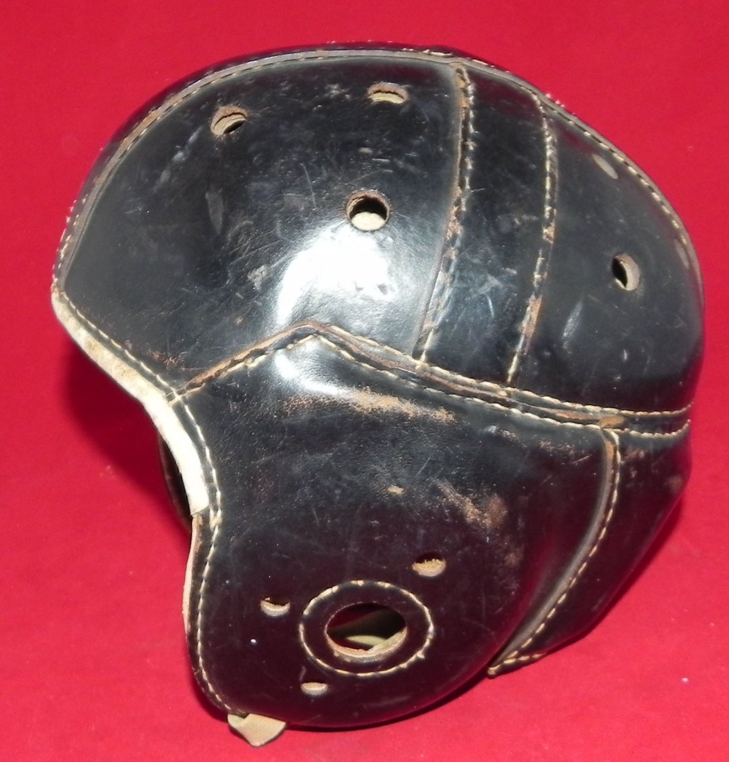 Antique 1930's Rawlings Leather Football Helmet: This lot is a 1930's Rawlings brand leather football helmet. The helmet features black leather, and has a Rawlings maker's mark, as well as the model number A25 on its back side. The helmet is in exce