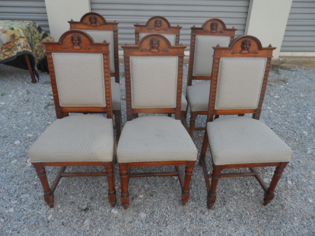 Set of 6 English Antique Mahogany Dining Chairs: Set of 6 antique Enlish mahognay dining chairs. Each chair features a carved face of a period dated woman and have been reupholstered. Measures 41" tall x 18" wide x 17" deep. Seat bottom measures 20"