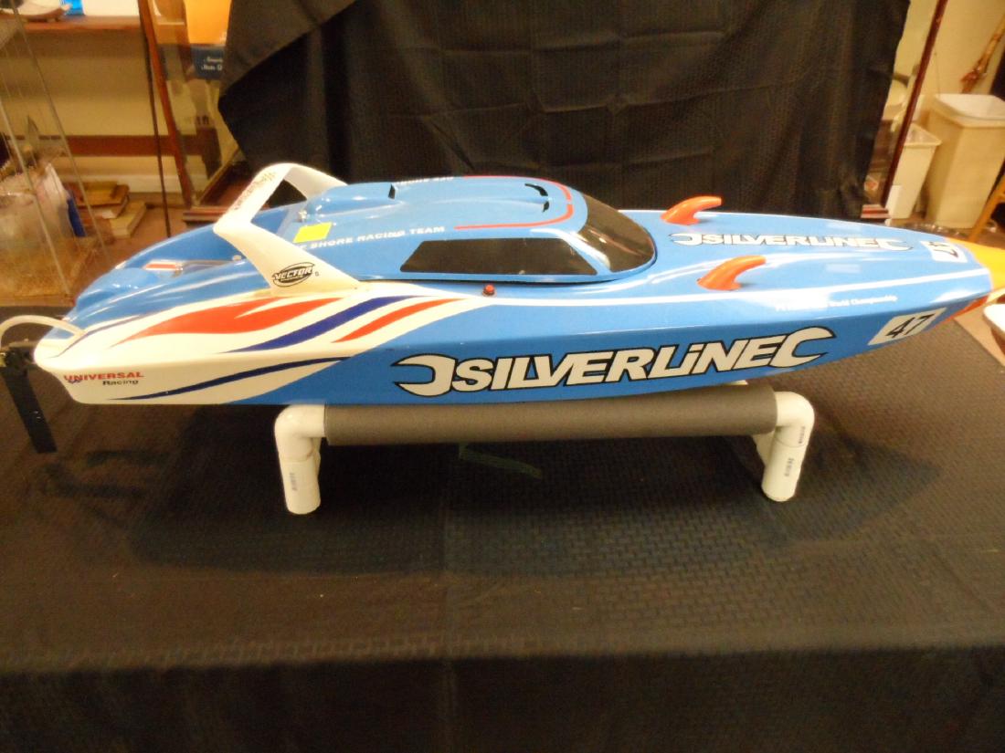 Silver Line Universal Model Racing Boat: Silverline Universal model racing boat with brand new motor and stainless steel prop. Includeds 3PL-2.4G remote, made by Futaba. Measures 52" long x 14" wide.