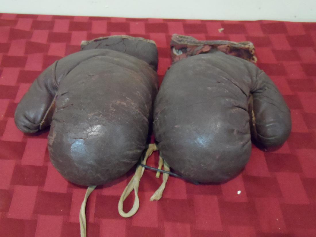 Vintage Children's Leather Boxing Gloves: Vintage childres leather boxing gloves. Condition 5 of 10 with slight cracking in leather.