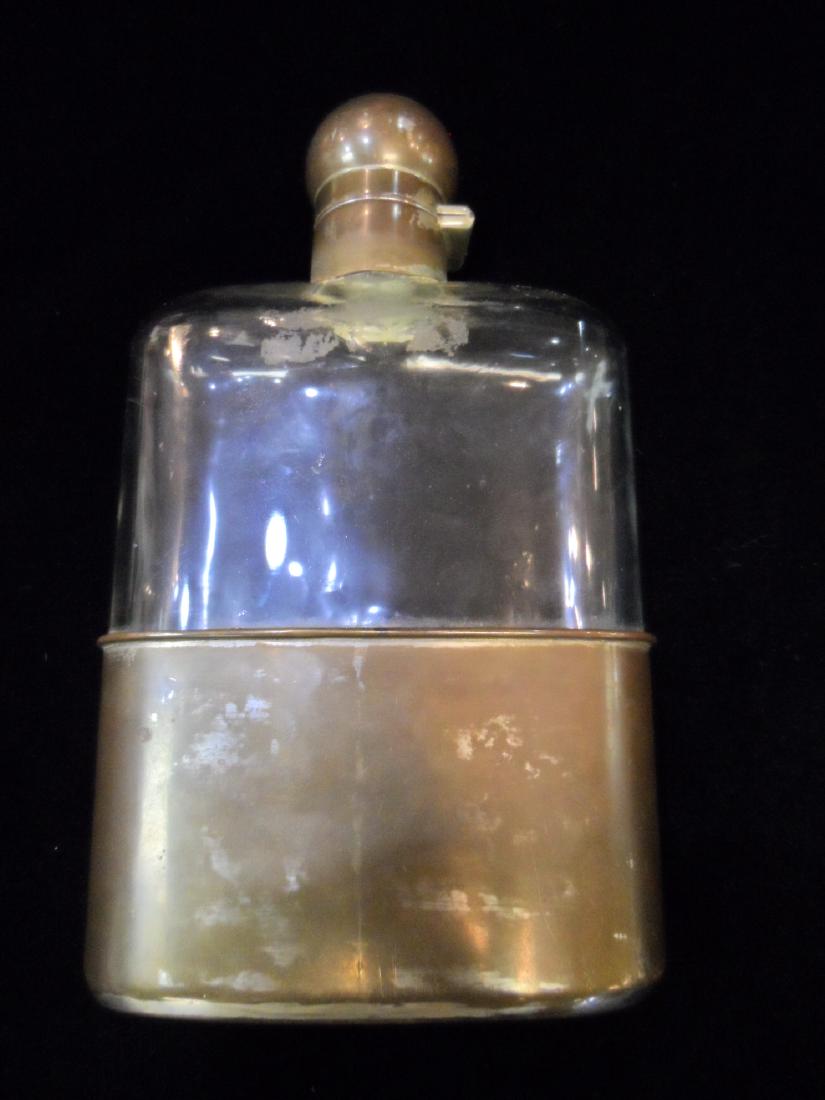 Antique Glass Flask: Antique silver plated and glass flip top flask. Flask is 1 pint and in good condition with a ding in the top.