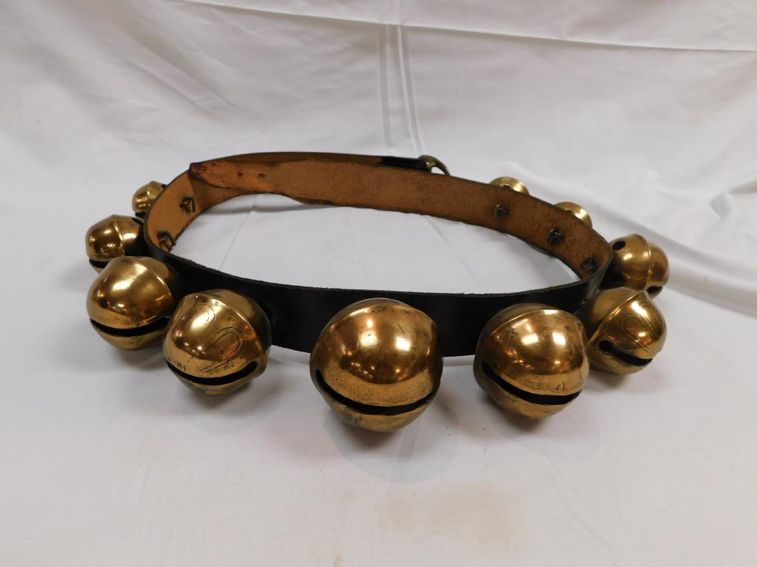 Set of Vintage Sleigh Bells: Set of vintage brass sleigh bells attached to a leather strap. In overall excellent condition with 10 total sleigh bells . Strap measures 48" long