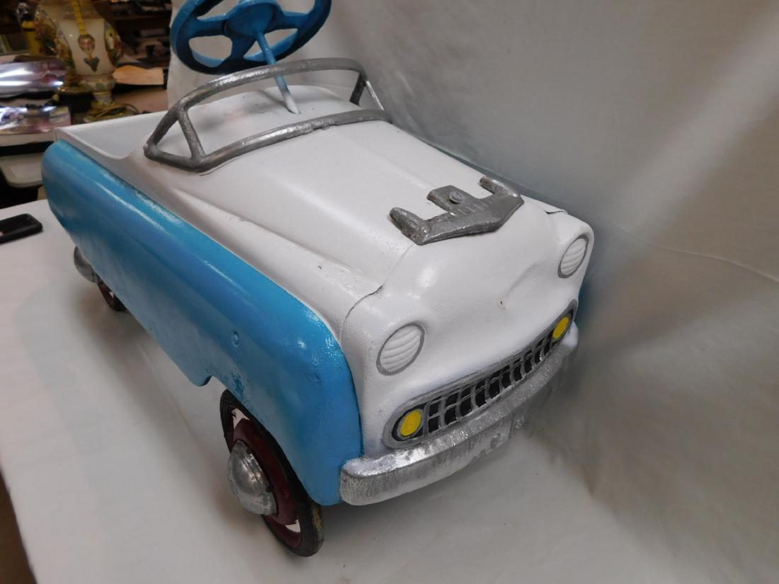 Vintage Metal Peddle Car: Vintage metal peddle car. Car is in fair condition, has been repainted and shows signs of pitting throughout. Measures 36x15"
