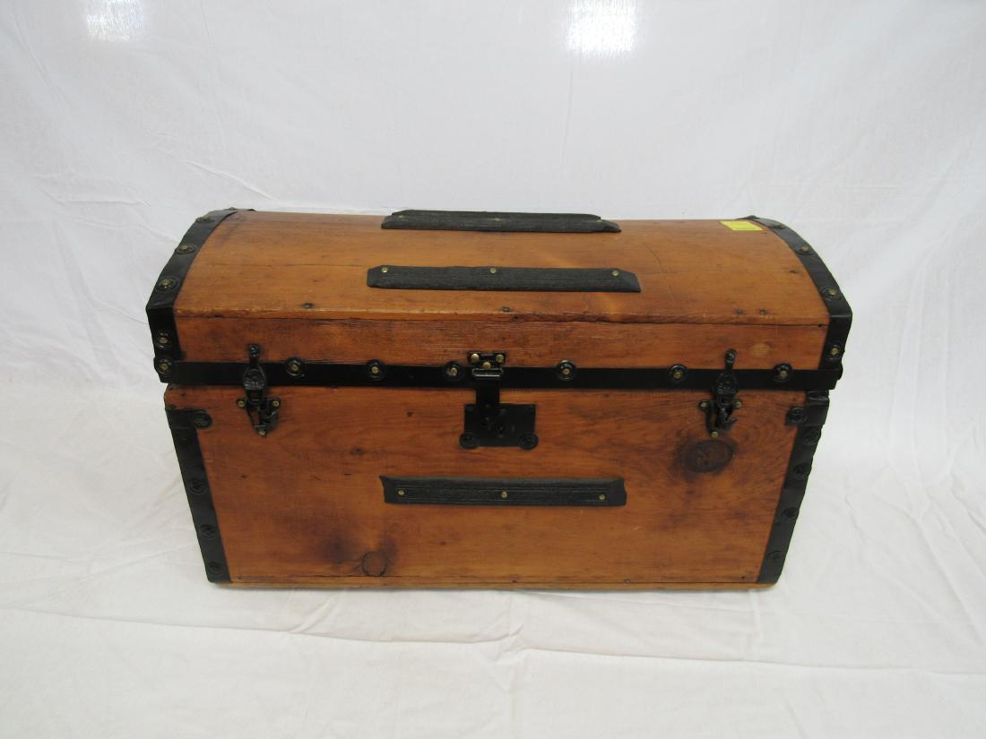 Early Camel Back Trunk: Early Camel Back Trunk with original tray and key. Trunk has wooden handles. Measures 16.5" tall x 13.5" wide x 27" long.