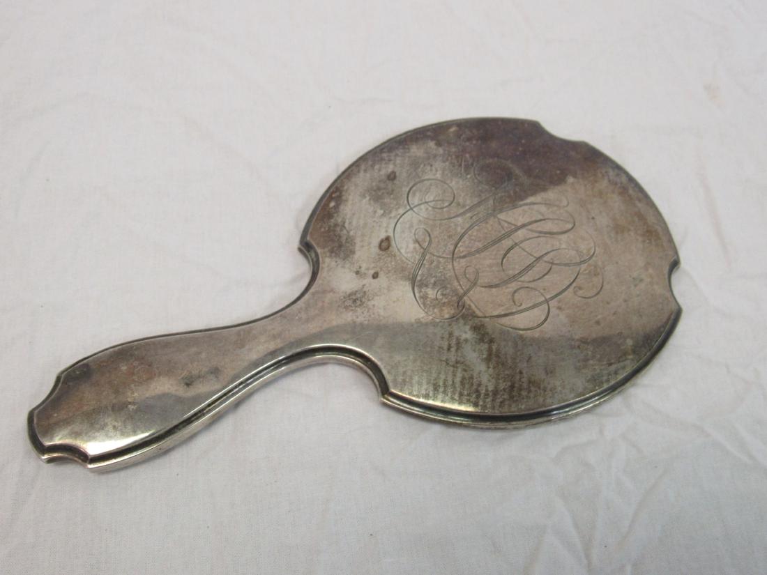 Antique Sterling Hand Mirror: Antique Sterling Hand Mirror. Glass is beveled, back is monogrammed. Measures 9.5" tall