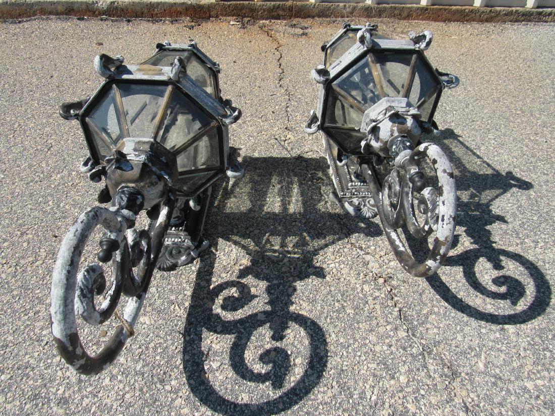 Pair of Ornate Outdoor Sconces: Pair of Ornate Outdoor Sconces. Sconces came off a large estate home in St. Augustine, Fl. 2 lights per sconce. Measures 25" long x 12" wide.