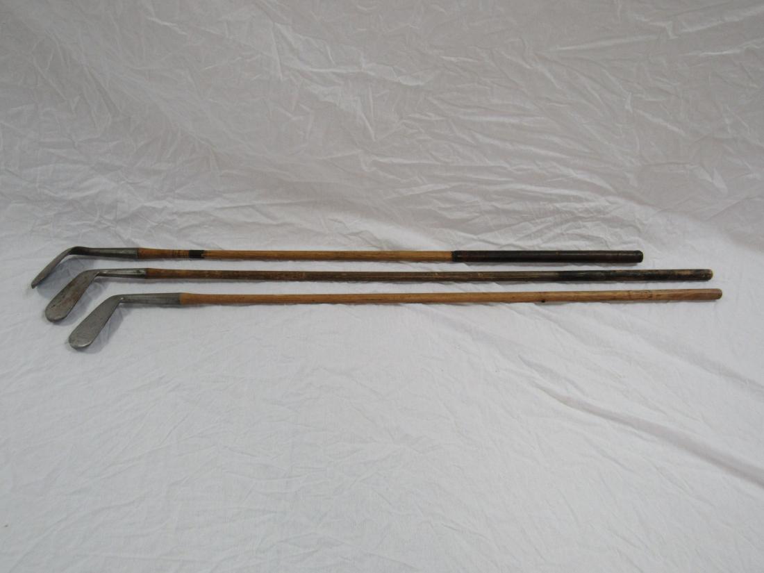 Lot of 3 Antique Wooden Golf Clubs: Lot of 3 Antique Wooden Handle Gold Clubs. One a Spaulding (missing grip), One unknown (missing grip), the other a Ray Cole Niblick (Cracked shaft).