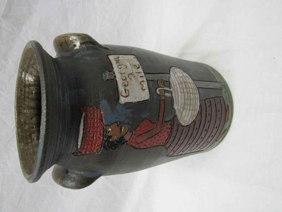 Outsider Folk Art Marvin Bailey Crock: Outsider Folk Art Marvin Bailey Crock. Crock depicts a African American standing next to a Georgia mile marker. Measures 10" tall