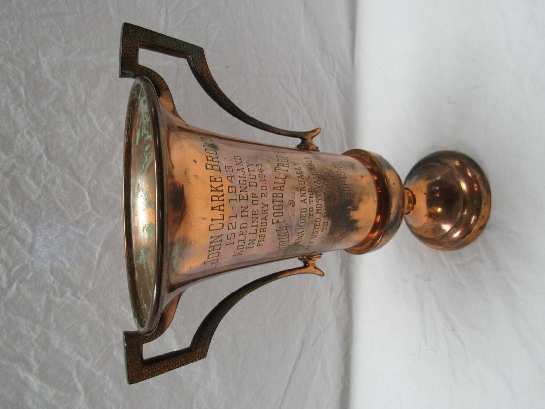 WWII Era Football Trophy: WWII Era Football Trophy. Trophy awarded to Most Valuable Football Player. Trophy constructed of brass reads "Lt. Clarke Brown 1921-1943. Killed in England in Line of Duty. February 20, 1943. Memorial