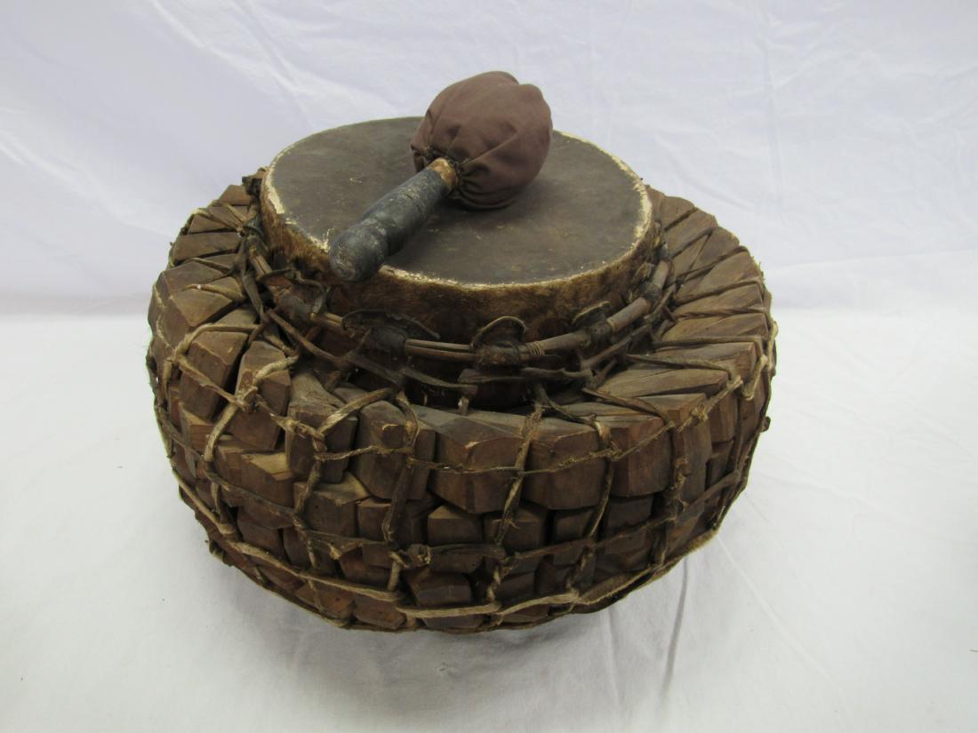 Vintage Traditional Indonesian Drum: Vintage Traditional Indonesian Drum. Double sided drum covered in animal skin and surrounded by 4 rows of wood wedges. With original drum stick. Measures 20" across.