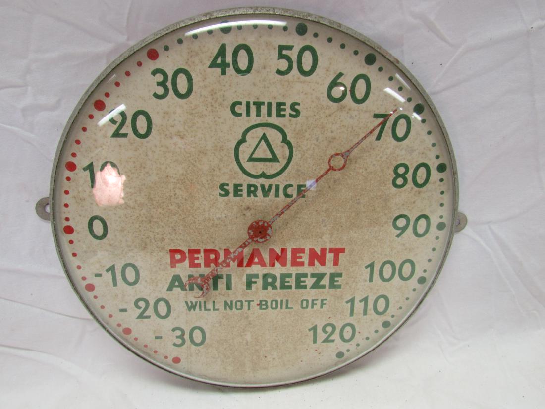Early Cities Service Thermometer: Early Cities Service Thermometer. In excellent working condition, paint missing on hand. Reads, "Cities Service, Permanent Anti Freeze Will Not Boil Off". Measures 12" across.