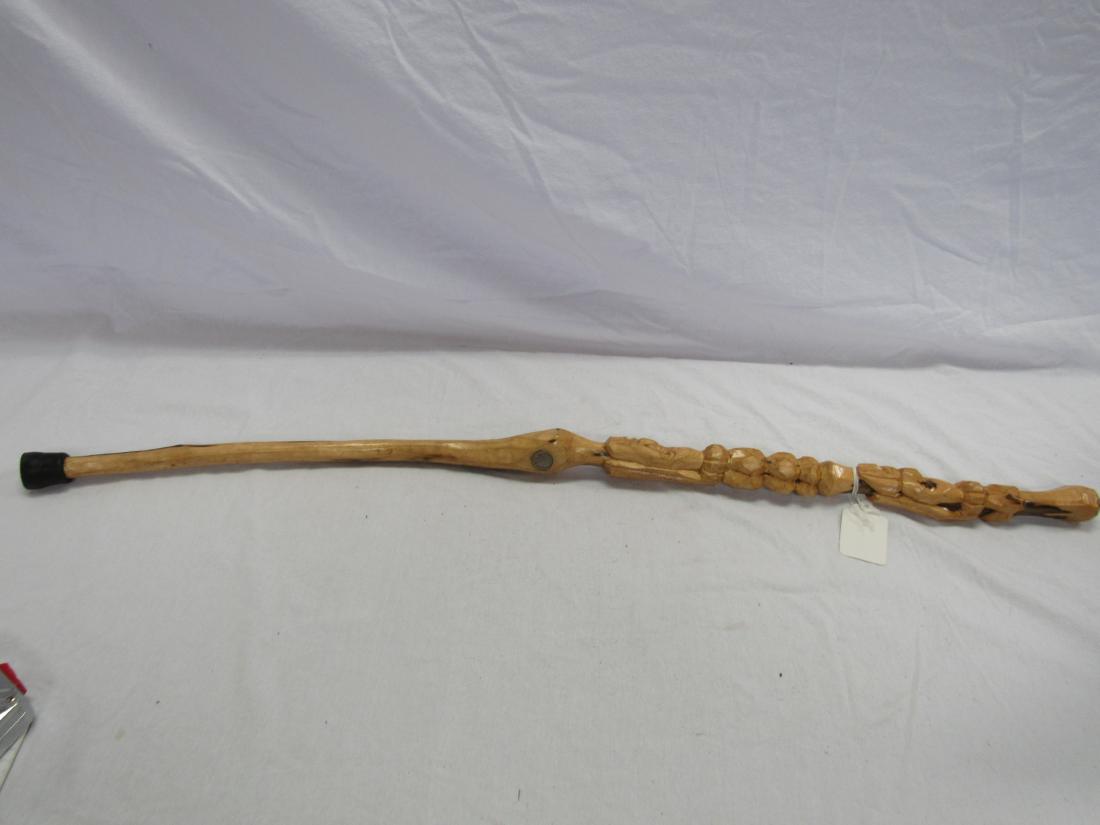 Hand Carved Folk Art Cane: Hand Carved Folk Art Cane. Cain depicts 2 faces and a buffalo nickel. Signed David. Measures 42" long.