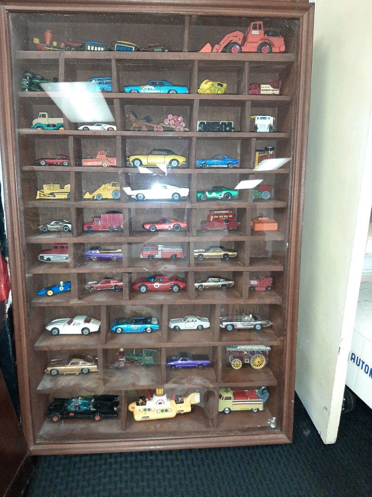Lot of Vintage Toys in Shadow Box: Lot of Vintage Toys in Shadow Box. Brands included are Corgi (Bat Mobile, The Beetles Yellow Submarine, etc), several Red Line Hot Wheels, and a whole lot more. Shadow box measures 17.5" x 30".