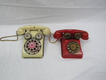 Lot of 2 Antique Metal Toy Phones: Lot of 2 Antique Metal Toy Phones. In overall very good condition. The red phone is made by The N.N. Hill Brass Co and in working condition, the white phone made by the Pla Phone and not in working co