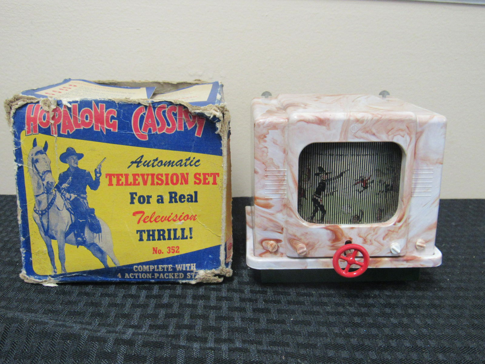 1950's NOS Toy Hopalong Cassidy Automatic Television: 1950's NOS Toy Hopalong Cassidy Automatic Television Set. In original box with paperwork. TV Set in very good condition. Box in poor/fair condition. TV measures 5" x 5" x 4.5"