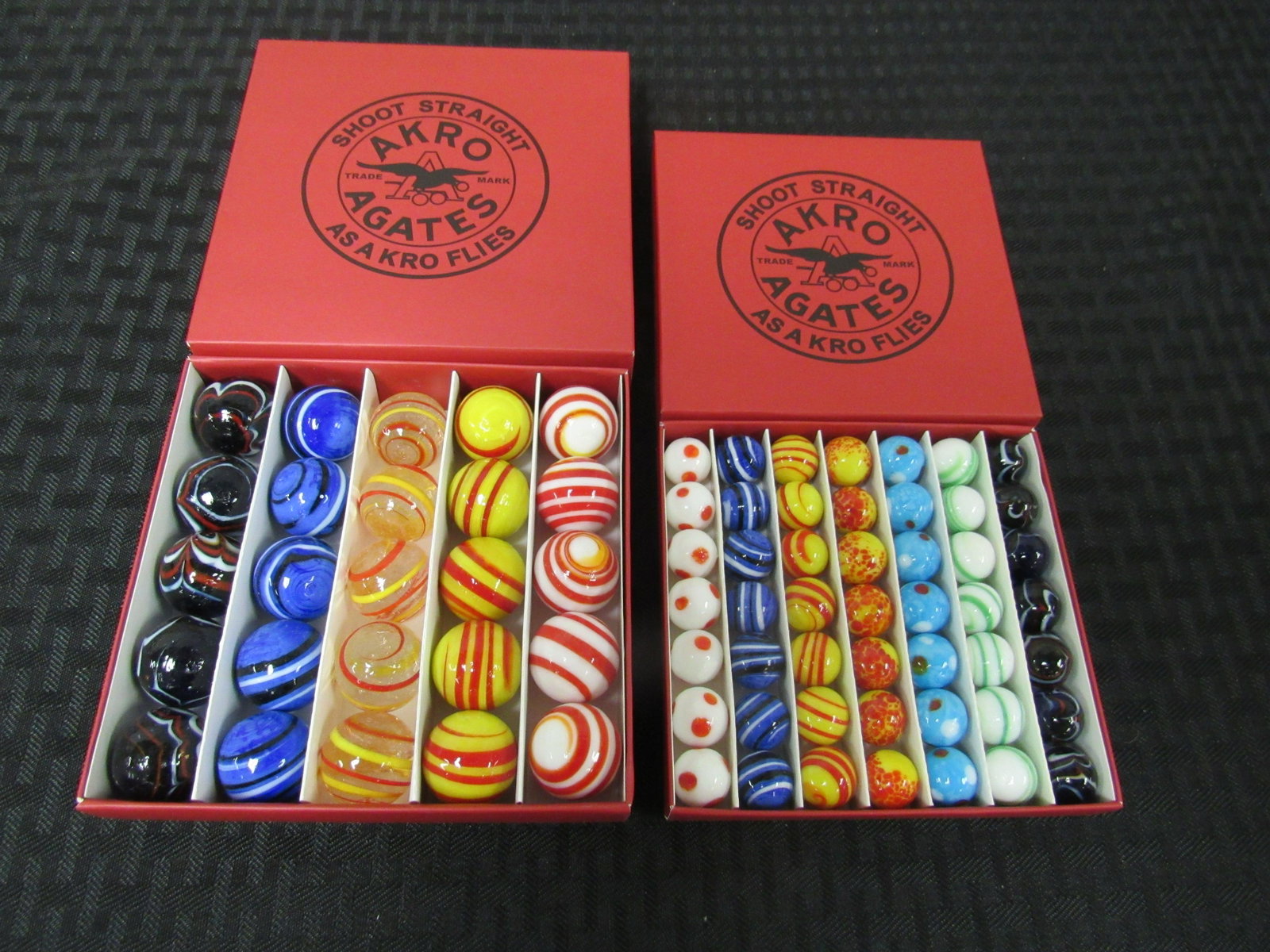 Lot of 2 Boxes of Akro Agates Marbles: Lot of 2 Boxes of Akro Agates Marbles. 1 box of 25 shooters, 1 box of 49 regular marbles