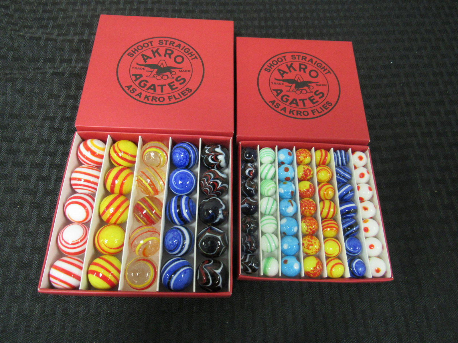Lot of 2 Boxes of Akro Agates Marbles: Lot of 2 Boxes of Akro Agates Marbles. 1 box of 25 shooters, 1 box of 49 regular marbles