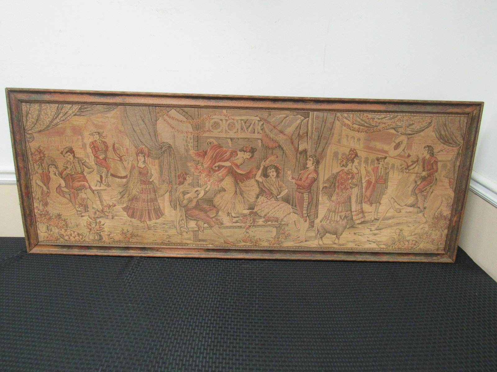 Framed Antique Tapestry: Framed Antique Tapestry. Depicts several different Spanish scenes. Housed in period frame. Tapestry and frame in fair to good condition. Framed measures 21.5" x 57.5"