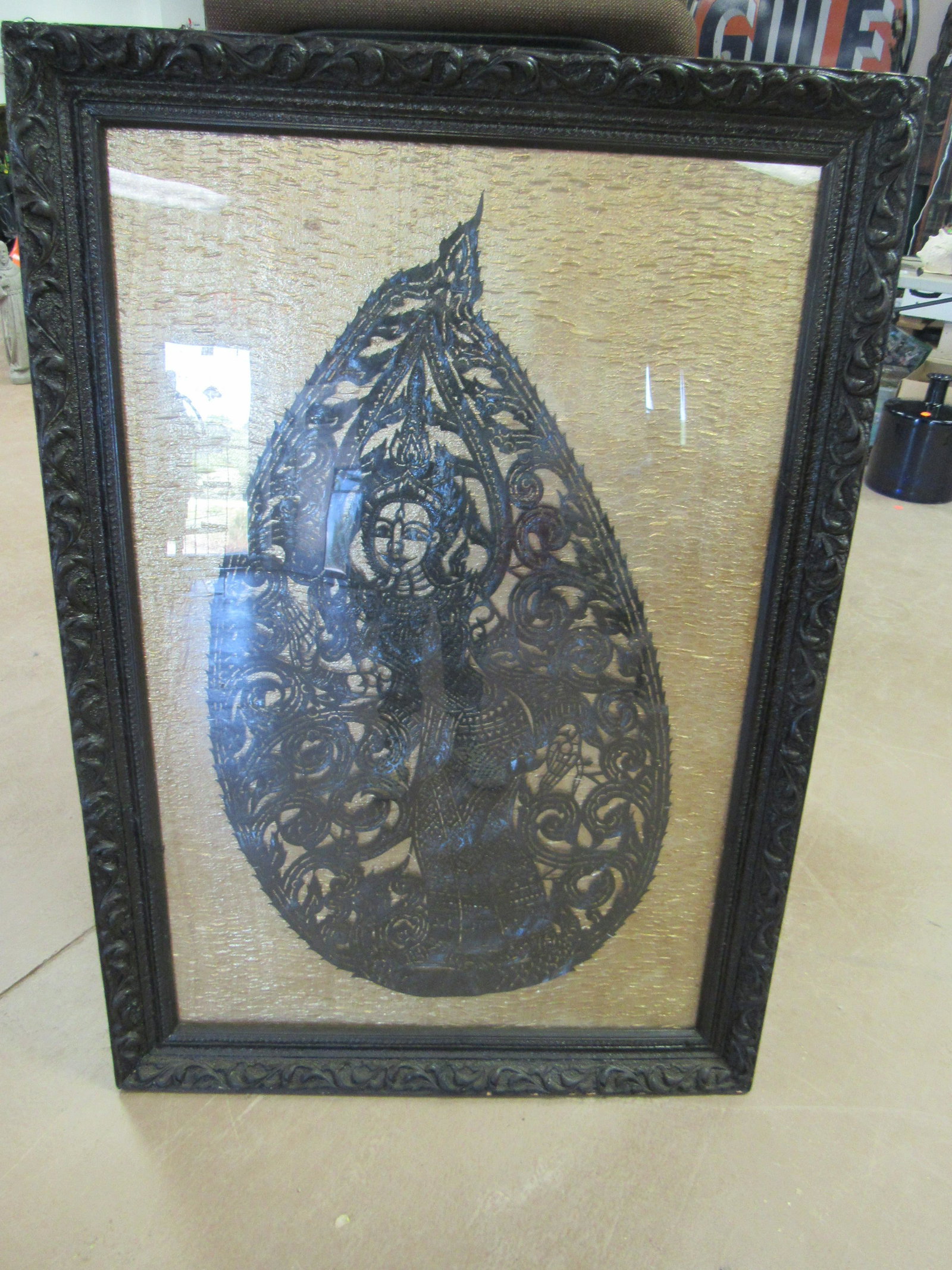 Antique Thai Shadow Puppet: Antique Thai Shadow Puppet. Puppet is hand carved and constructed of buffalo hide. Puppet is framed on silk. Excellent condition. Overall measures 40" x 22". Framed 50" x 34.75"