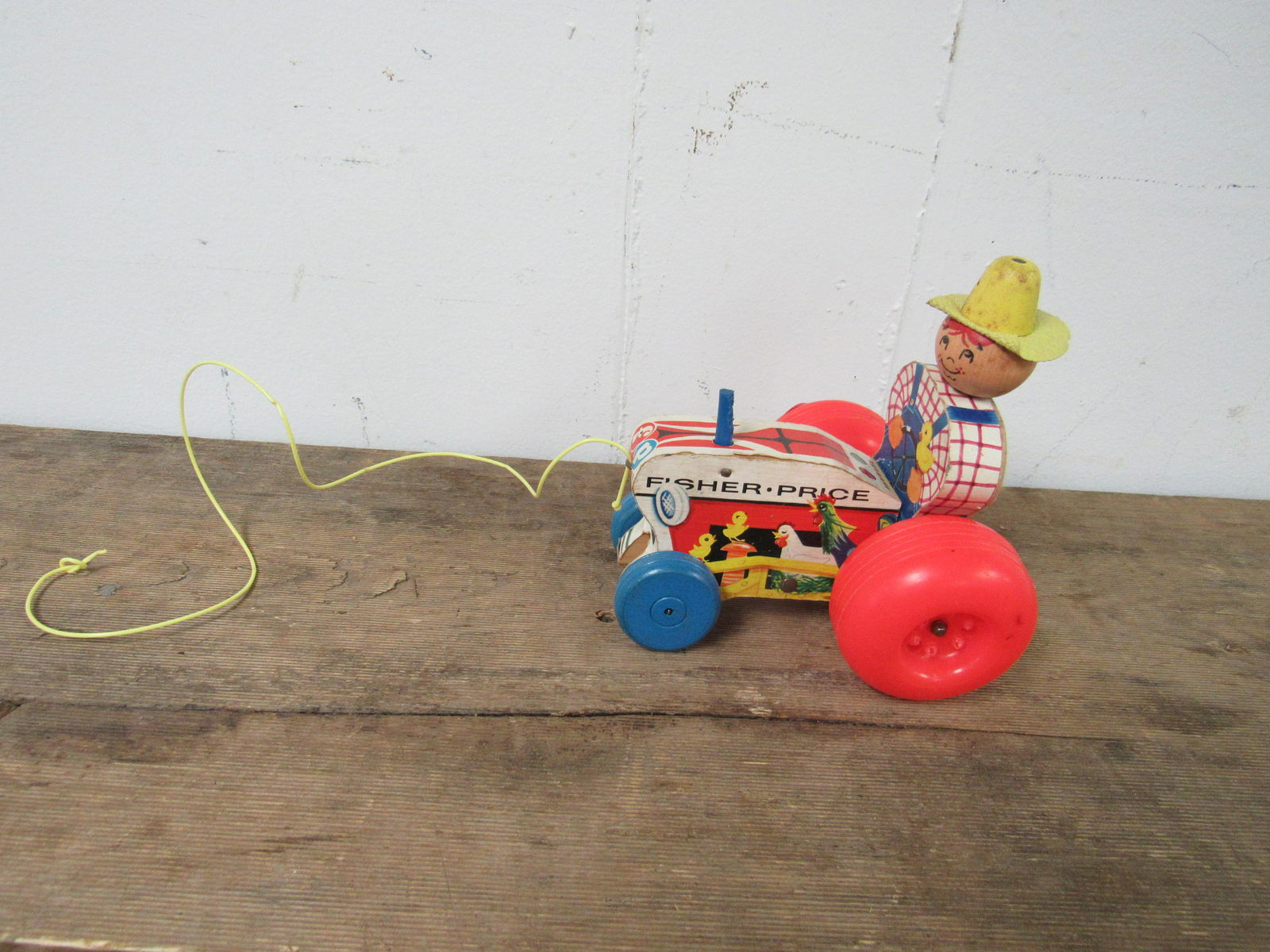 Vintage Fisher-Price Mighty Tractor Farmer Child's Pull: Vintage Fisher-Price Mighty Tractor Farmer Child's Pull Toy. Very good, working condition. Constructed of wood. Dated 1961. 5" long