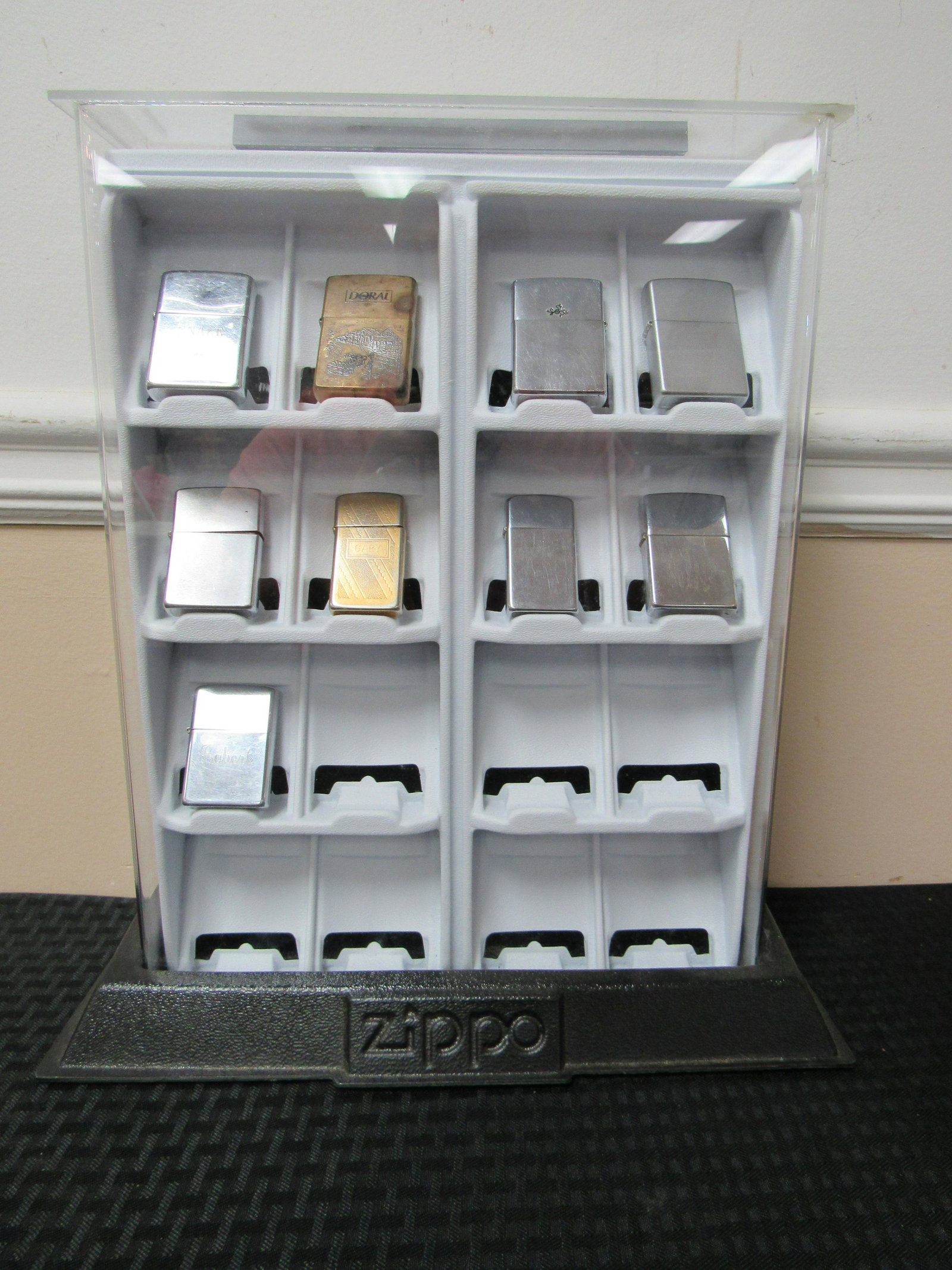 Vintage Zippo Display with 9 Zippo Lighters: Vintage Zippo Display with 9 Zippo Lighters. Display in good condition. No key. Zippos range different ages. All in good to very good condition. Case measures 15" x 13.75" x 6"