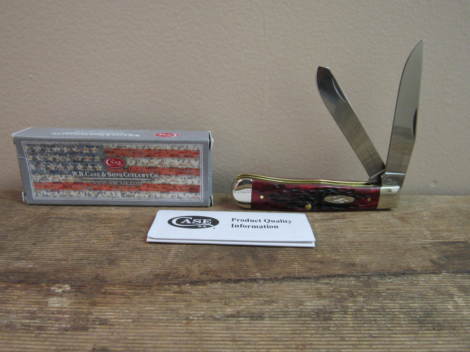 NIB Case XX Two Blade Trapper Knife with Crimson Red: NIB Case XX Two Blade Trapper Knife with Crimson Red Bone Peachseed Handle. Measures 7.25" opened, 4" closed
