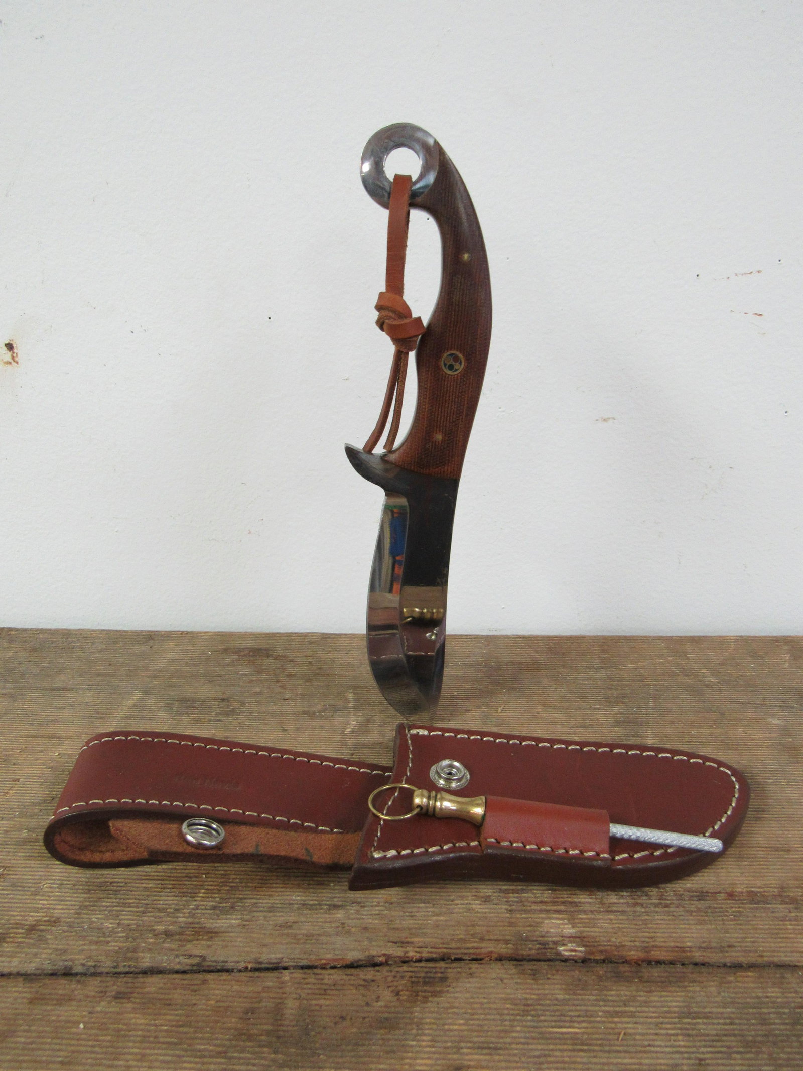 Ben Nevis Custom Handmade Knife in Leather Sheath: Ben Nevis Custom Handmade Knife in Leather Sheath. Very good condition. With Sharpener. Wood handle. Blade measures 4.5", Knife 9.25"