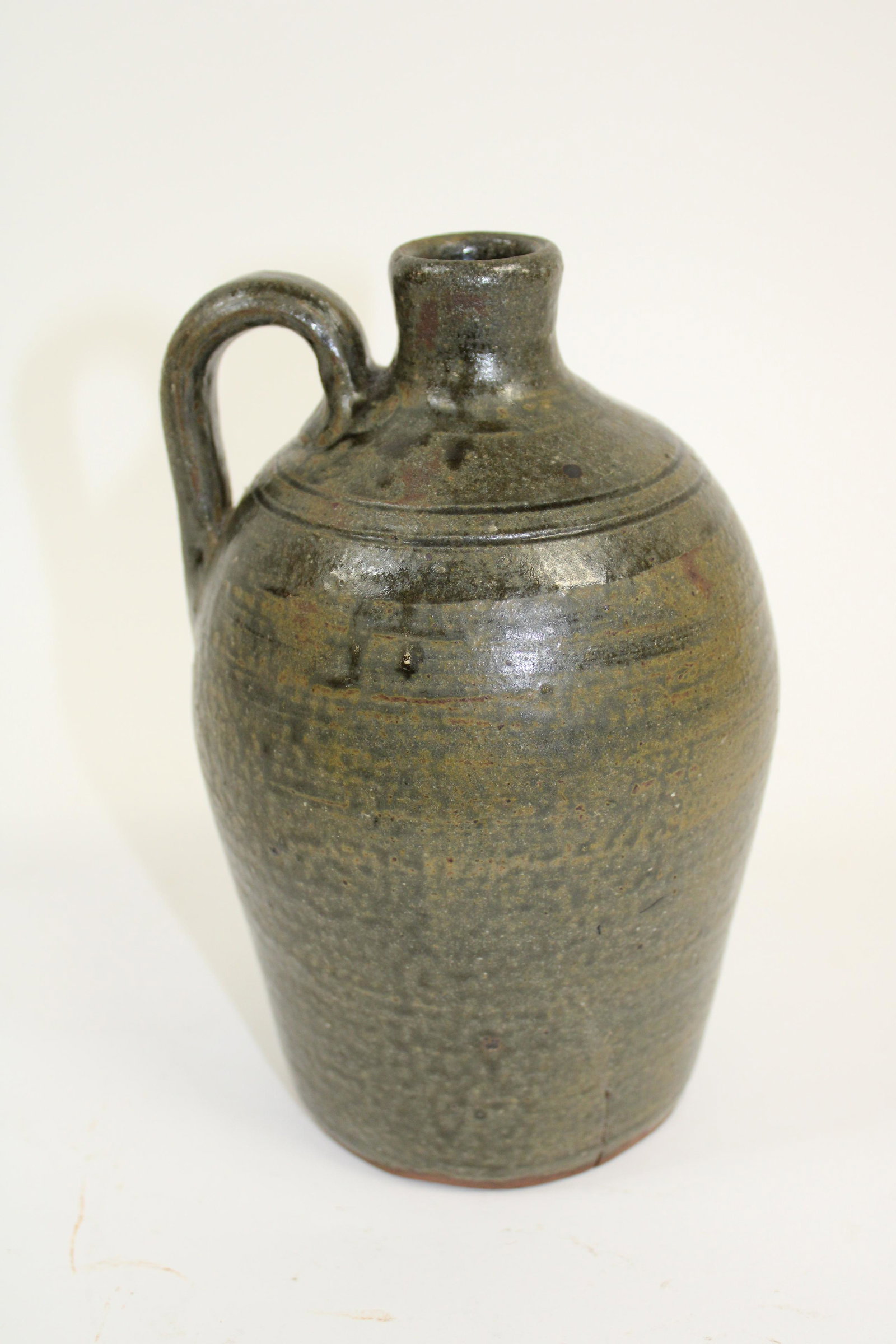 Cleveland Ga John Meaders 1 Quart Alkaline Glazed Jug.: Cleveland Ga John Meaders 1 Quart Alkaline Glazed Jug. Overall fair condition with large kiln crack, as photographed. Measures 8".