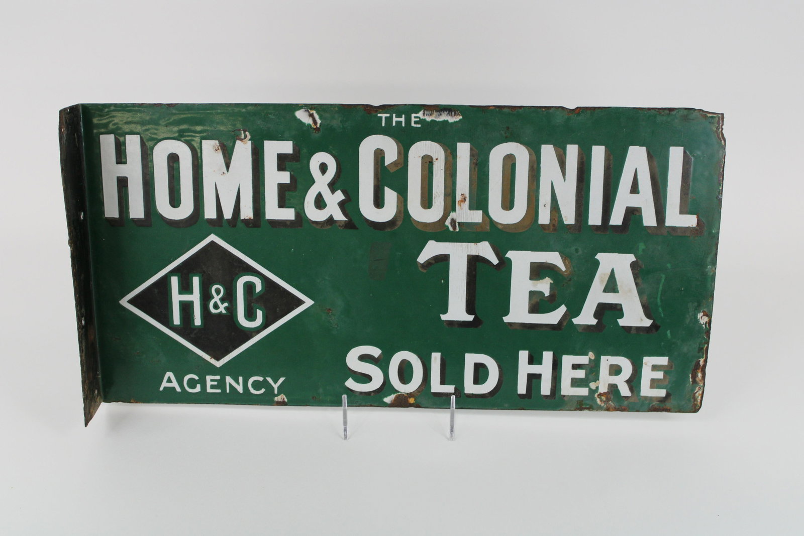 Circa 1920: Circa 1920's-1930's 20" x 10" DSP Home and Colonial Heavy Porcelain Flange Sign. Overall good condition. Double sided, damage on edges and field on either side. 7.5/10