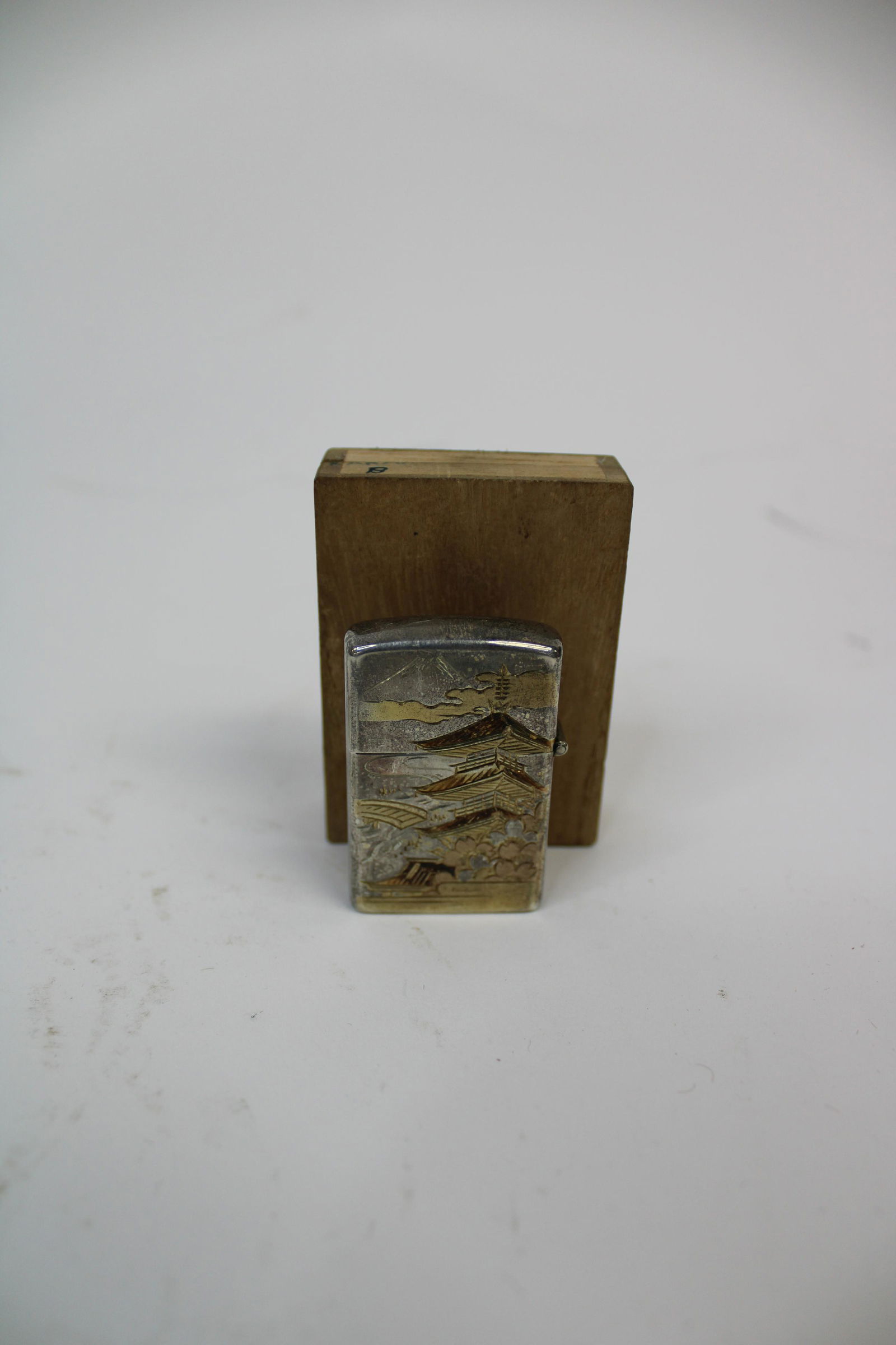 World War II Sterling Silver Lighter Depicting Japanese: World War II Sterling Silver Lighter Depicting Japanese Scene. Overall excellent condition with original box. Lighter Measures 2" x 1", Box measures 2.5" x 1.75". Bottom marked sterling silver.