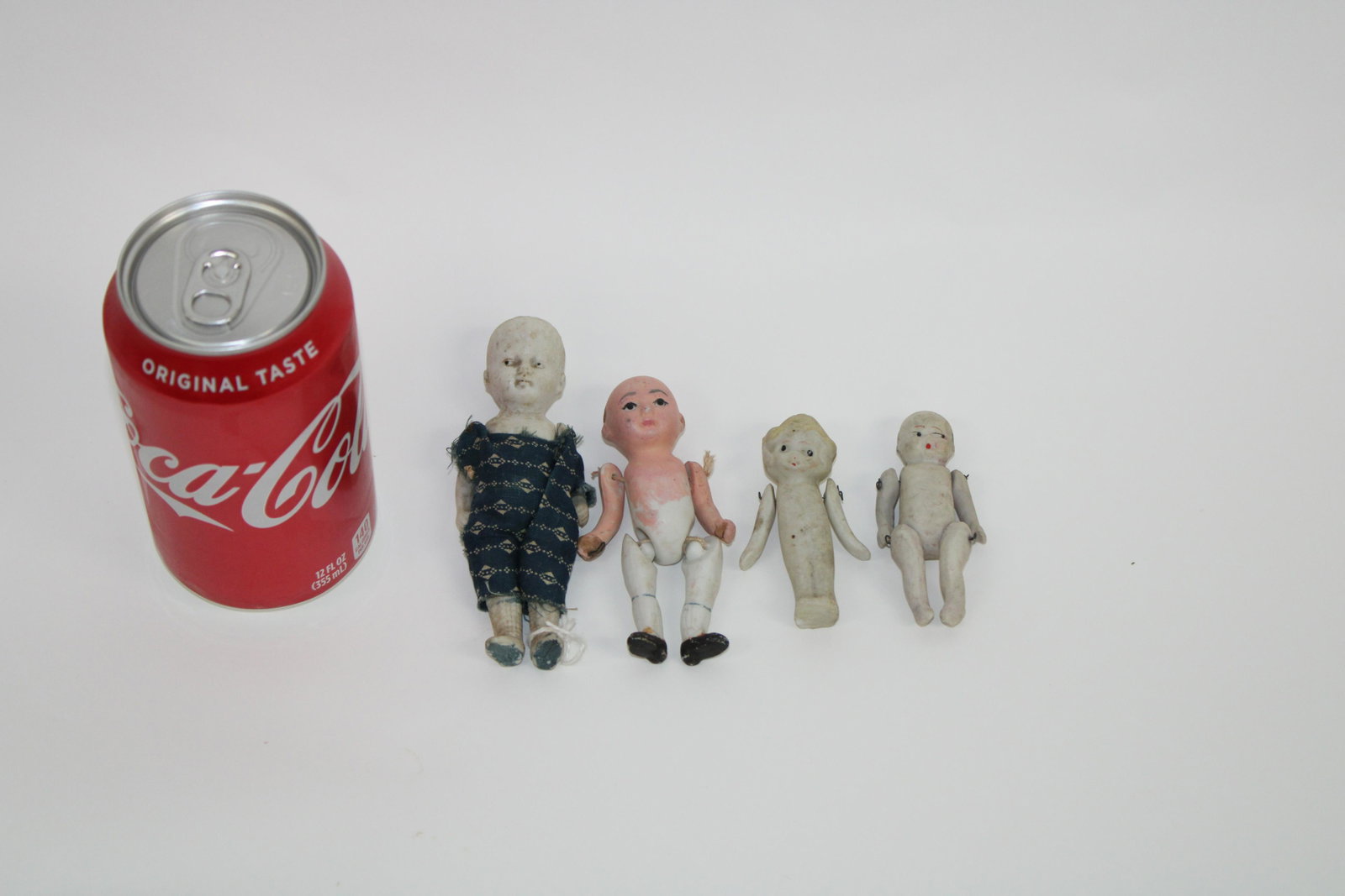 Lot of 4 Antique Jointed Porcelain Dolls.: Lot of 4 Antique Jointed Porcelain Dolls. Lot contains 4 porcelain dolls. 2 marked Japan, 1 marked Nippon, 1 marked Adonicf. All 4 good condition. Measurements range 2.5" - 5.5".