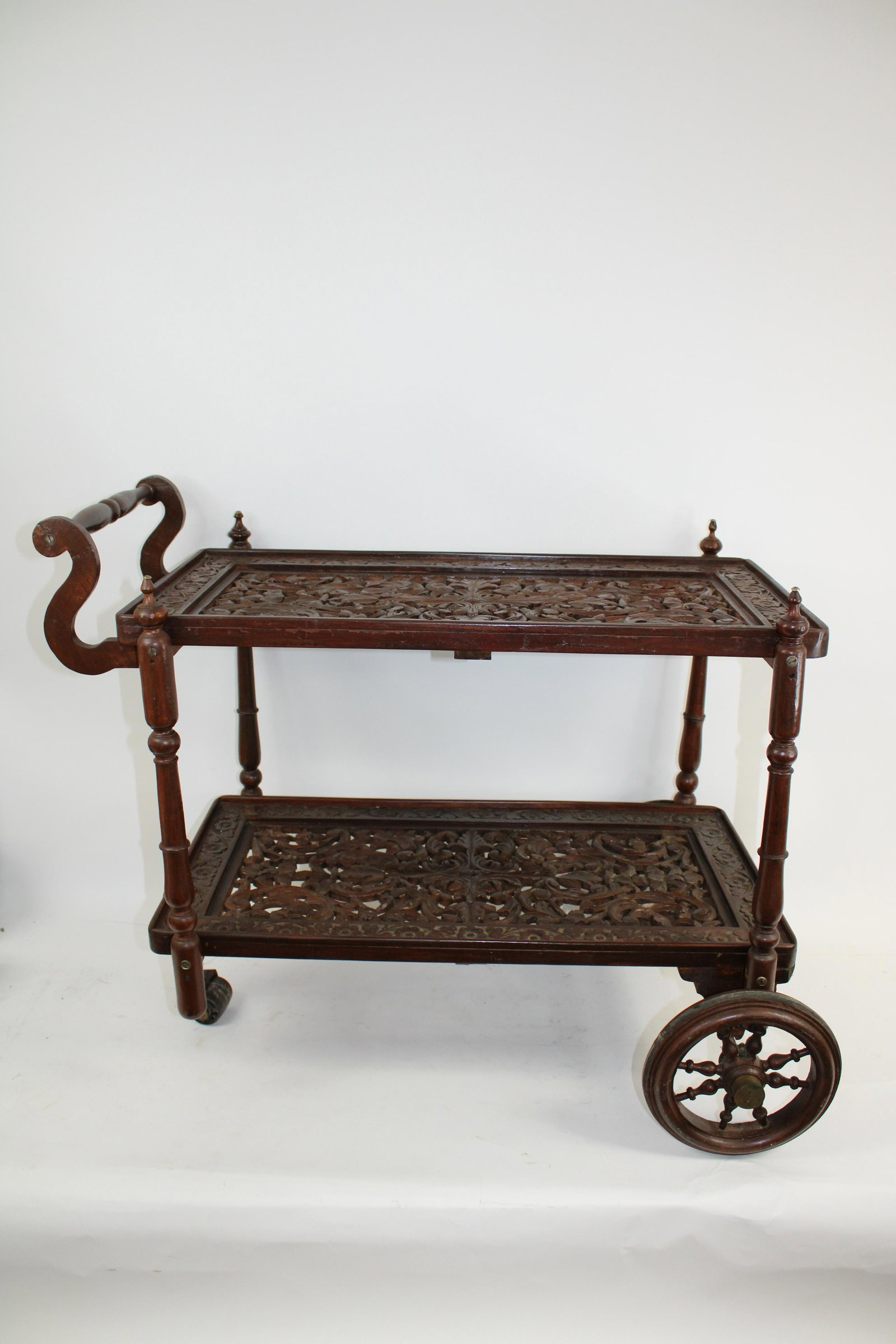 Mid Century Ornately Carved Mahogany Tea Cart: Mid Century Ornately Carved Mahogany Tea Cart. In overall very good condition. Measures 33.5 x 22 x 28.5