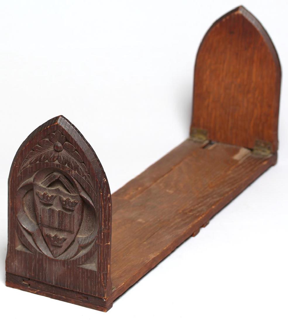 Hand-Carved Oak Gothic Revival Expanding Bookends: Each Romanesque-arched end finely carved with a quatrefoil enclosing the seal of Oxford University in England. Closed: 7.5" H X 17.25" W.