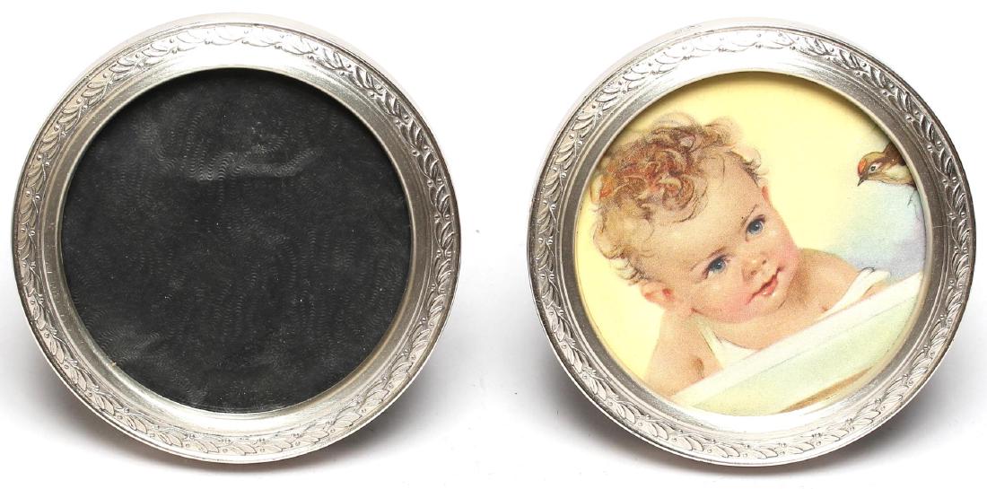 Pair of Web Silver Co. Sterling Picture Frames: Small and circular, with a tiny band of leaves and berries, the rims stamped "WEB Sterling." 3.25" diameter. Approx. 1.25 ozt.