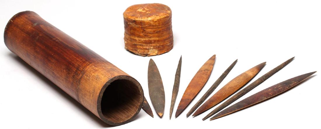 Ethnographic Bamboo Spear Tip Holder: The tube with an animal hide cover, enclosing a number of carved wood spear points and darts. 12" L. Wear consistent with age and use.