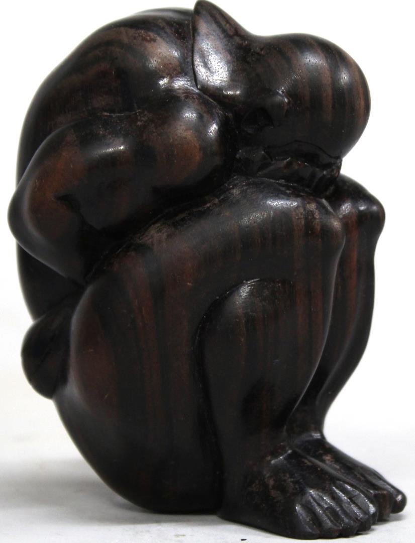 Macassar Ebony Figure of a Mourning Man: Depicted doubled over with grief, head in hands, clad in a headdress and loincloth. 4\\\" H.