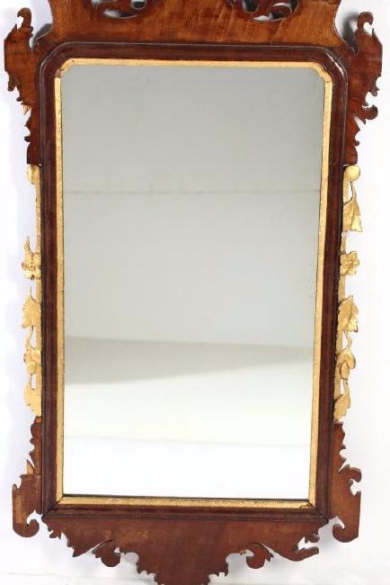 Antique Chippendale Giltwood Mahogany Mirror: Late 18th/early 19th century, with foliate and winged frame edged by gilt floral and leaf motifs. 42" H X 22.5" W. Losses to crest and giltwood sides; shrinkage cracks to veneer; new backing.