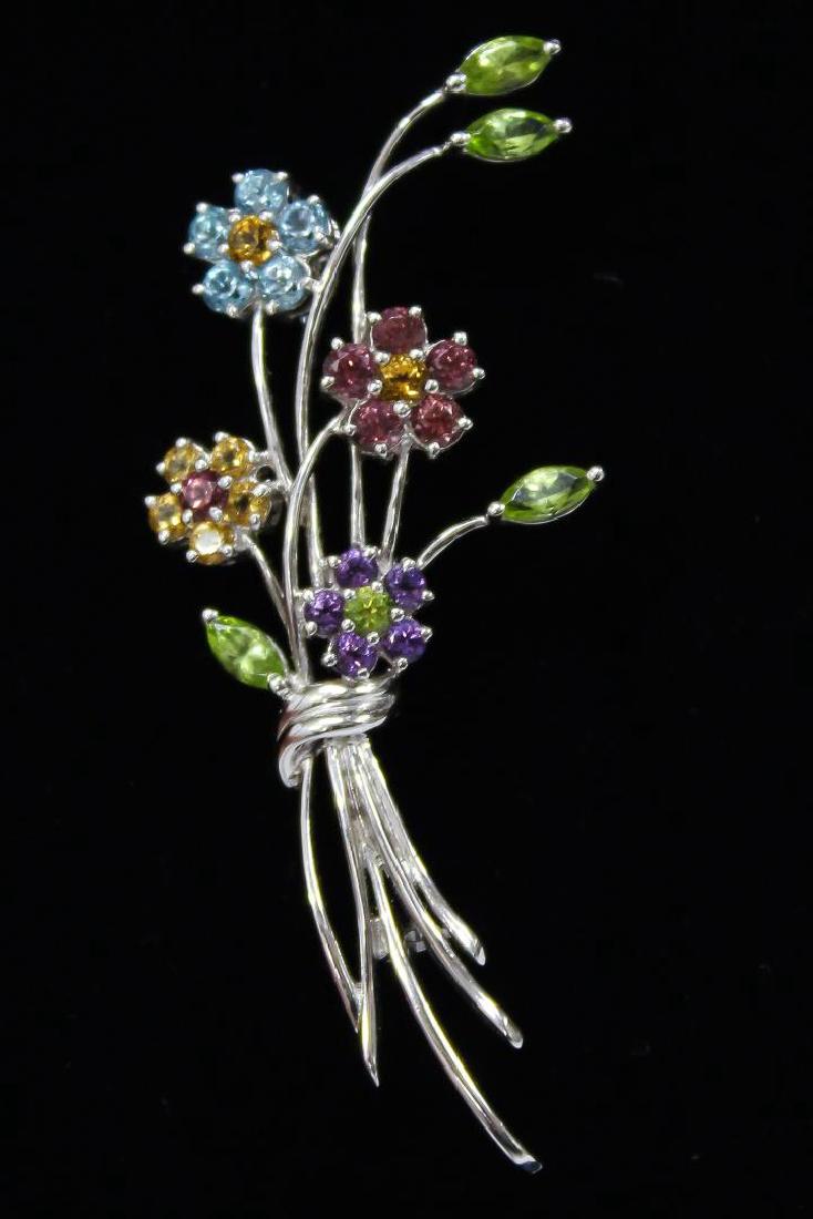 Fortunoff 18K White Gold & Gemstone Floral Brooch: The flowers consisting of peridots, pink and red tourmaline, and yellow spinel, marked on the reverse "750" and "Fortunoff." 2.5" L. Approx. 5.4 DWT (incl. stones).