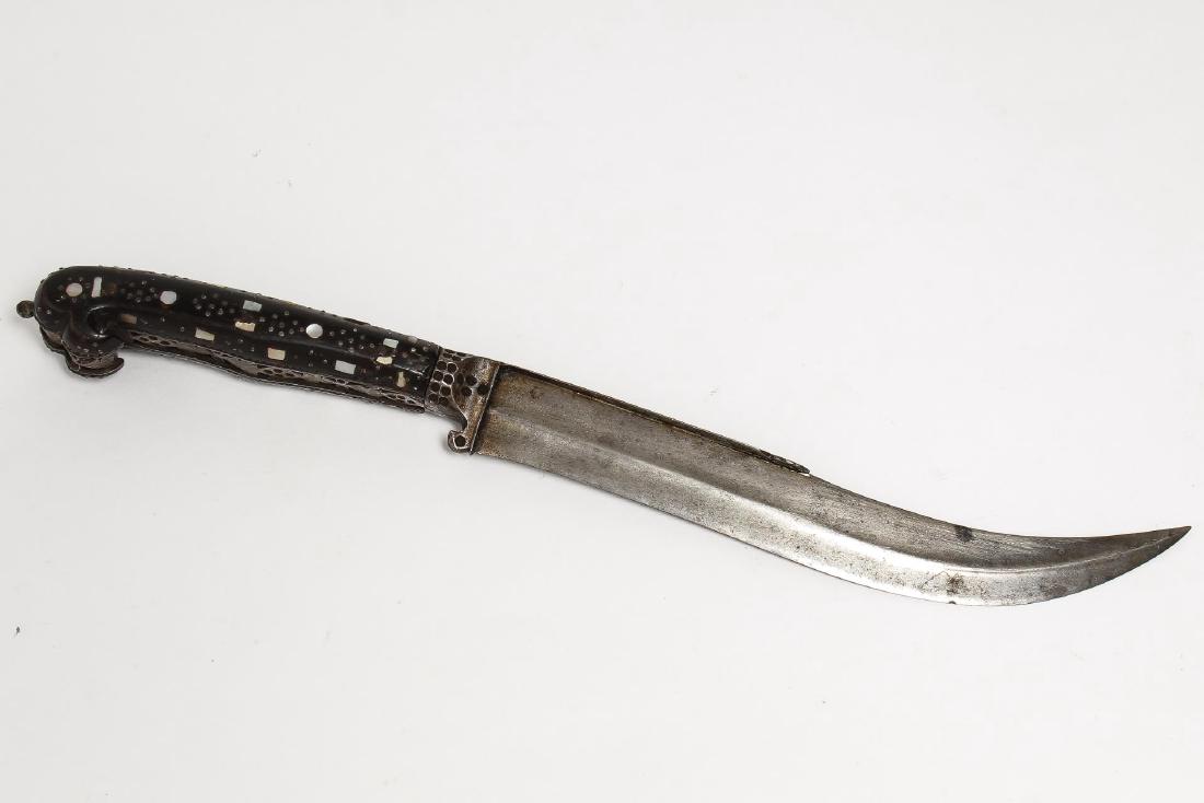Vintage Middle Eastern Curved Blade Dagger: The openwork steel and wood handle set with bone and mother-of-pearl designs. 12" L. Lacking scabbard; minor losses to pearl chips and wood, with an old acquisition number "303."