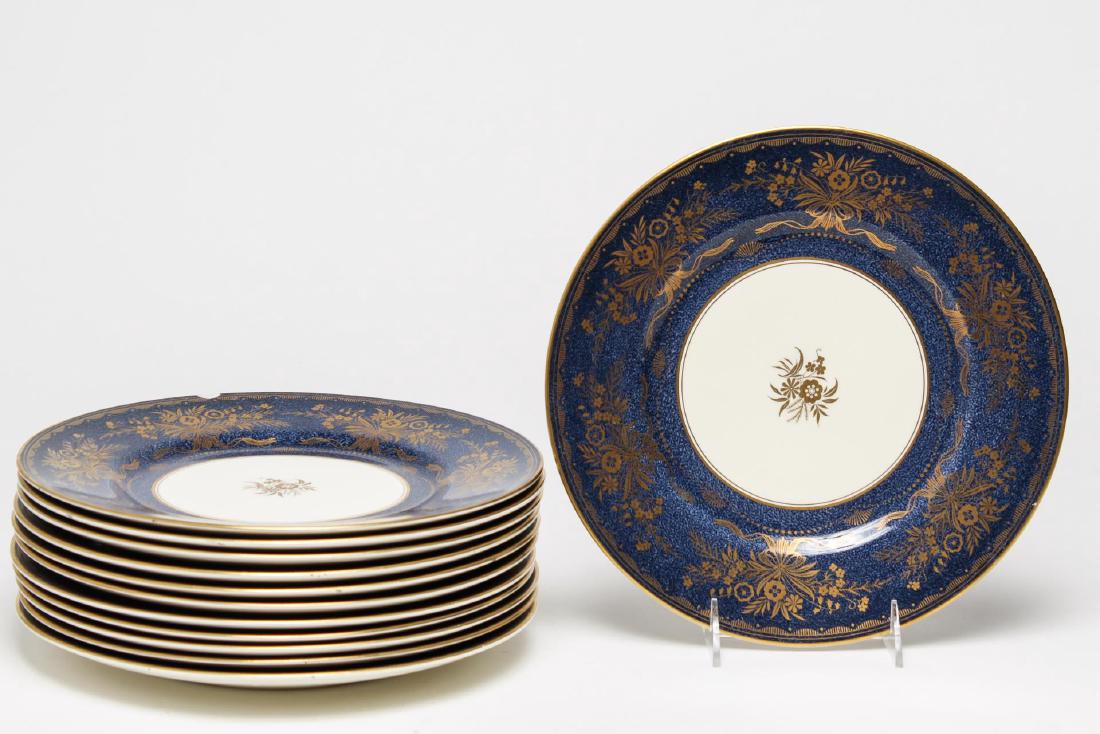 Minton Bone China- Set of 12 Dinner Plates: English porcelain with mottled blue rims and elaborate gilding, maker's mark of 1912-1950 underneath. Each 10.5" diameter. One with a rim chip, another with minor crazing to underside.