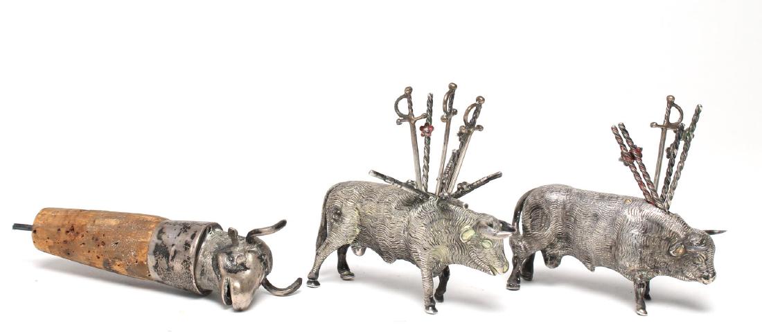 3 Sterling Silver Bull-Form Articles: Comprising wine stopper and two toothpick holders with ten silver toothpicks, one bearing maker's mark "LSG / 0925," the other bearing maker's mark of Jose Marmolejos. Stopper: 3.75" L; bull: 1.5" H X